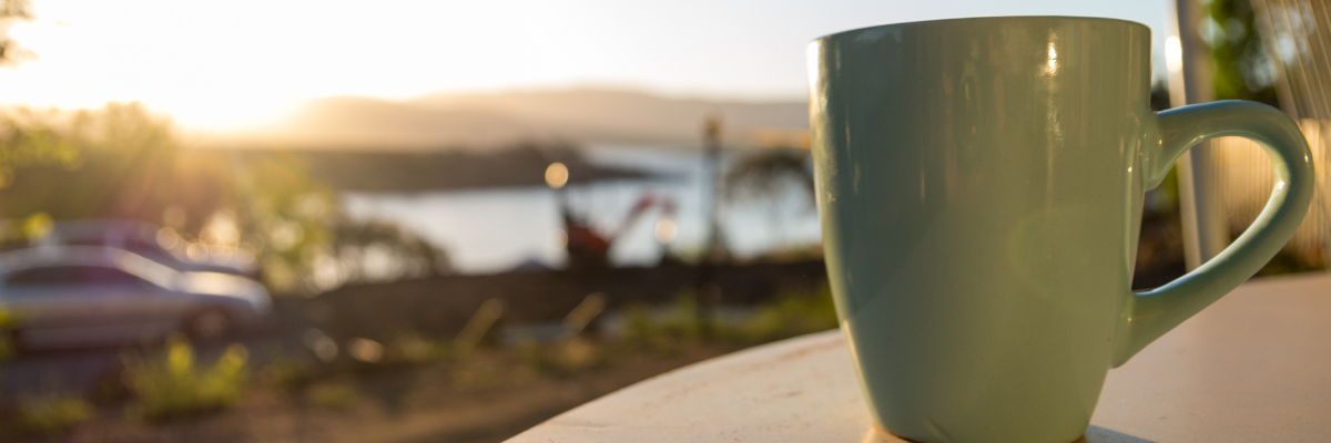 Morning coffee cup at sunrise representing peace and lifestyle changes from keto
