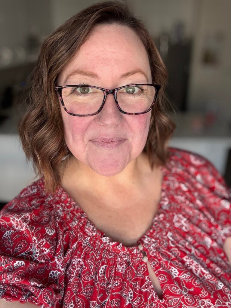 a photo of the Keto With Amy creator in a red floral top.