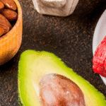 Keto grocery list for beginners with avocado, almonds, red meat, eggs, and cheese.